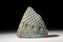 EGYPTIAN FAIENCE WIG INLAY

 New Kingdom, 18th Dynasty, Ca. 1550 - 1295 BC
 A blue turquoise-coloured, glazed wig inlay from a composite figure. Th...