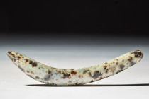 EGYPTIAN GLASS BROW INLAY 

 New Kingdom, Ca. 1550 - 1070 BC 
 An arching brow formed of glass which would have conjoined with a correspoding eye i...