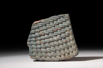 EGYPTIAN TURQUOISE GLAZED COMPOSITION WIG FRAGMENT

 New Kingdom, Ramesside Period, Ca. 1550 - 1186 BC
 A turquoise coloured wig inlay from a compo...