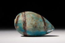 EGYPTIAN FAIENCE VOTIVE MODEL OF A FIG 

 Middle Kingdom, Ca. 2055 - 1773 BC
 A hollow dark green glazed faience egg-shaped ball, perhaps a model o...