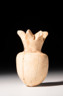 EGYPTIAN CALCITE BOTTLE IN THE FORM OF A POMEGRANATE

 New Kingdom, Ca. 1295 - 1069 BC
 A bottle, in the shape of a pomegranate, the exact purpose ...