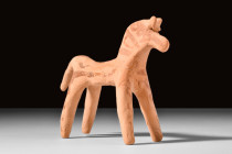 BOEOTIAN TERRACOTTA HORSE 

 Ca. early 6th century BC
 A charming terracotta horse with simplified features, depicted in a standing pose on four lo...