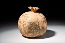 GREEK TERRACOTTA VOTIVE POMEGRANATE 

 Eastern Greek, Ca. 400 BC
 A naturalistic sculptural rendering of a pomegranate with a characteristically gl...