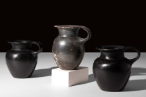 GROUP OF THREE ATTIC BLACK-GLAZED VESSELS

 Ca. 450 BC
 A group of three black glazed cups, each with a well-proportioned, bulbous body, gradually ...