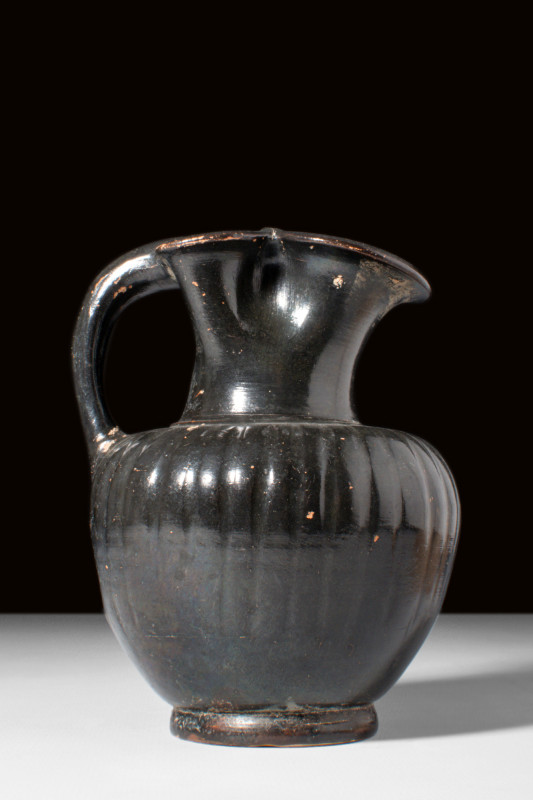 GREEK SOUTH ITALIAN BLACK-GLAZED RIBBED OINOCHOE

 Ca. 4th century BC
 A blac...