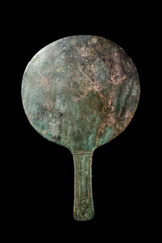 ETRUSCAN BRONZE HAND MIRROR

 Ca. 400 BC
 A bronze mirror of a circular form ...