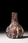 ROMAN GLASS AUBERGINE 'WHITE MARBLED' RIBBED BOTTLE 

 Ca. AD 100
 An Aubergine 'white marbled' ribbed bottle with ovoid body; no rim; short neck; ...