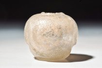 ROMAN MINATURE GLASS BOTTLE

 Ca. AD 100 - 300
 A minature small glass bottle with a rounded concave body leading up the shoulder, a small internal...