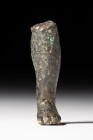 ROMAN BRONZE STATUARY FRAGMENT OF A LEG

 Ca. AD 200 - 300 
 A hollow-cast foot, originally from a small statue or a votive offering, made with toe...