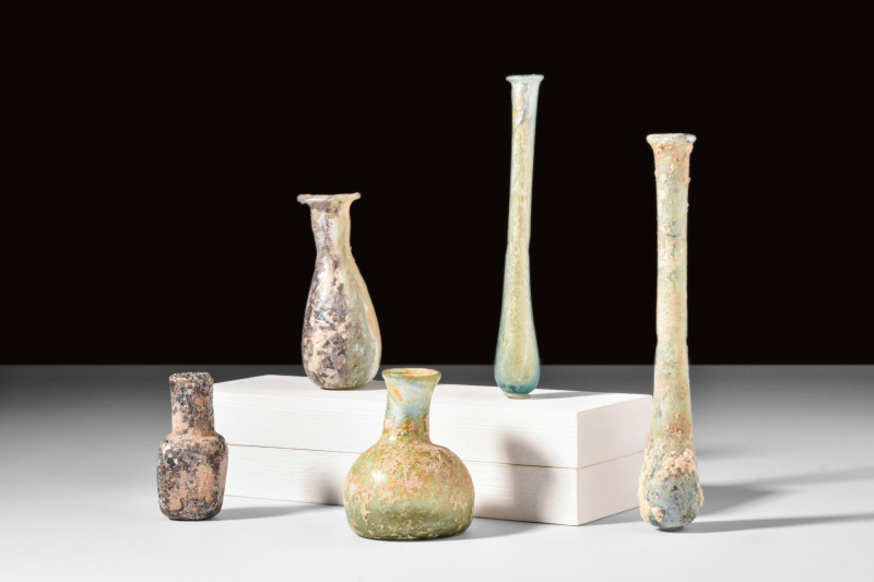 COLLECTION OF FIVE ROMAN GLASS BOTTLES

 Ca. AD 100-300 
 A group of five gla...