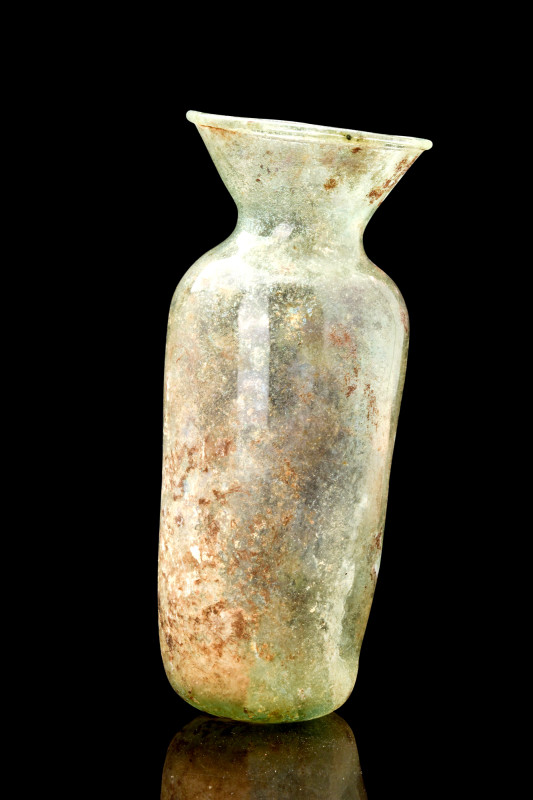 LARGE ROMAN GLASS BOTTLE

 Ca. AD 100-300
 A translucent glass bottle, featur...