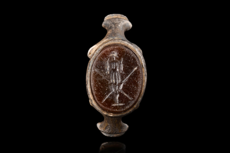 ROMAN SILVER RING WITH WAR TROPHY INTAGLIO

 Ca. AD 100-200
 A silver finger ...