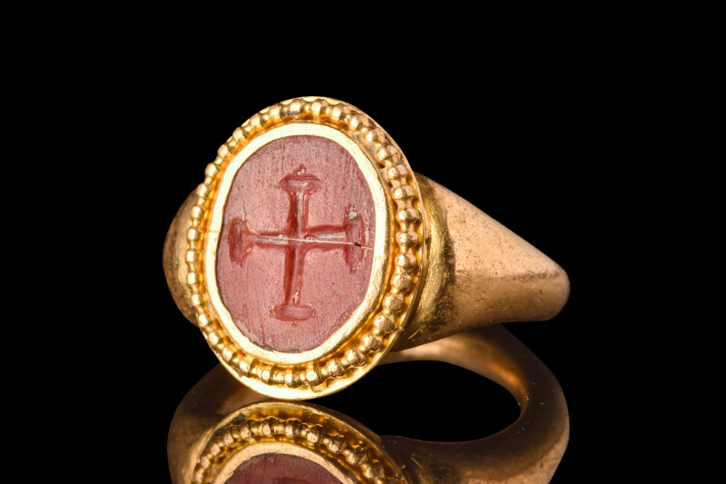 BYZANTINE CROSS INTAGLIO IN GOLD RING

 Ca. AD 600
 A gold finger ring compos...