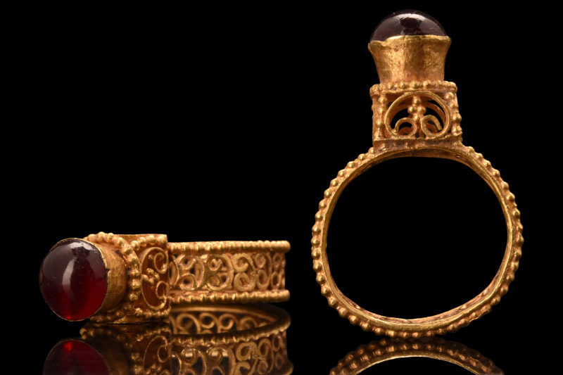 BYZANTINE ARCHITECTURAL GOLD RING WITH GARNET

 Ca. AD 600
 An elegant gold f...