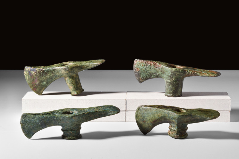 BRONZE AGE BRONZE GROUP OF FOUR AXE HEADS

 Western Asia, Ca. 2nd millennium B...