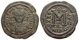 JUSTINIAN I (527-565).Nicomedia. Follis.

Obv : D N IVSTINIANVS P P AVG.
Helmeted and cuirassed bust facing, holding globus cruciger and decorated shi...