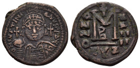 JUSTINIAN I (527-565). Cyzicus.Follis.

Obv : D N IVSTINIANVS P P AVG.
Helmeted and cuirassed bust facing, holding globus cruciger and shield decorate...