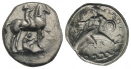 Southern Apulia, Tarentum, c. 340-335 BC. AR Nomos (22mm, 7.63g, 2h). Youth on horseback r., crowning horse; Φ to r.; below, youth removing stone from...