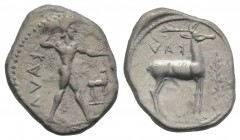 Bruttium, Kaulonia, c. 475-425 BC. AR Stater (24mm, 7.85g, 1h). Nude Apollo walking r., holding branch, holding small running daimon on outstretched a...