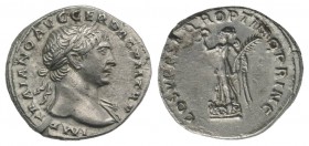 Trajan (98-117). AR Denarius (19mm, 3.48g, 7h). Rome, 107-111. Laureate bust r., slight drapery on l. shoulder. R/ Victory standing l. on shields, hol...