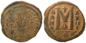 Justinian I, 527-565. Follis (bronze, 17.77 g, 32 mm). Constantinople. Helmeted, draped, and cuirassed bust facing, holding globus cruciger and shield...