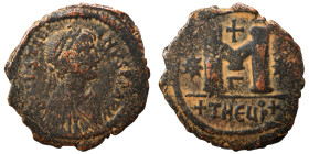 Justinian I, 527-565. Follis (bronze, 12.74 g, 31 mm), Theoupolis (Antioch). Pearl-diademed, draped, and cuirassed bust right. Rev. Large M; cross abo...