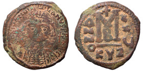 Justinian I, 527-565. Follis (bronze, 16.97 g, 34 mm), Cyzicus. Helmeted and cuirassed bust facing, holding globus cruciger and shield decorated with ...