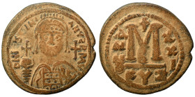 Justinian I, 527-565. Follis (bronze, 18.16 g, 35 mm), Cyzicus. Helmeted and cuirassed bust facing, holding globus cruciger and shield; cross to right...
