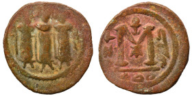 Arab-Byzantine. Umayyad Caliphate. Fals (bronze, 2.81 g, 19 mm). Three standing imperial figures. Rev. Large M; legend around. Nearly very fine.
