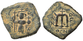 Arab Byzantine. Umayyad Caliphate, circa 641-660 AD. Fals (bronze, 4.59 g, 26 mm). Pseudo-Byzantine type, imitating the types of Constans II. Standing...