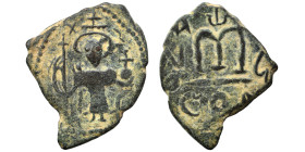 Arab Byzantine. Umayyad Caliphate, circa 641-660 AD. Fals (bronze, 3.76 g, 24 mm). Pseudo-Byzantine type, imitating the types of Constans II. Standing...