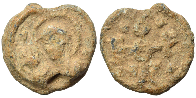 Byzantine seal (lead, 5.35 g, 18 mm). Nimbate saint facing. Rev. Monogram. Fine.