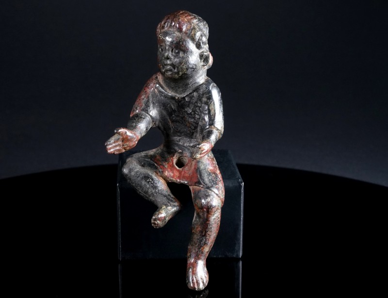 A ROMAN BRONZE STATUETTE OF A SEATED YOUNG BOY WITH TUNIC Circa 2nd-3rd century ...