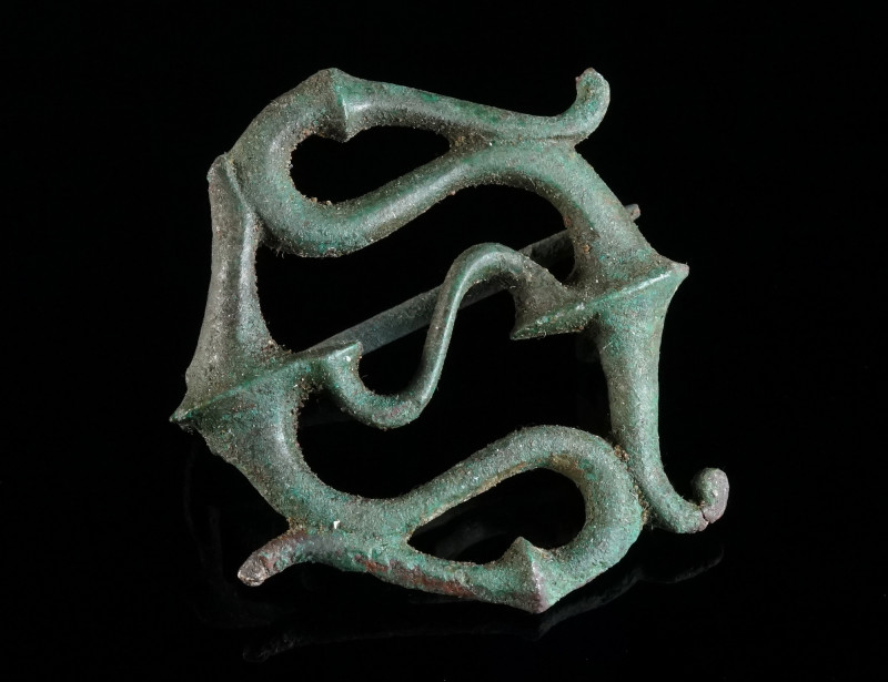 A ROMAN BRONZE OPENWORK TRUMPET BROOCH Circa 2nd-3rd century AD. Fine plate broo...