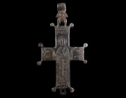 A BYZANTINE BRONZE RELIQUARY CROSS WITH ST. JOHN Circa 10th-12th century AD. Complete and lavishly decorated reliquary cross (enkolpion) depicting St....