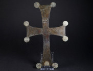 A LARGE BYZANTINE BRONZE PROCESSIONAL CROSS Circa 10th-12th century AD. Completely preserved cross with flaring arms, decorated in the corners with sm...