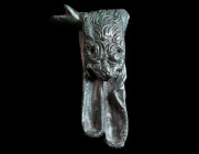 A ROMAN BRONZE LEFT ARM WITH LION SKIN Circa 1st-3rd century AD. Outstretched left arm with lion skin from a statuette of Hercules; the elaborately wo...