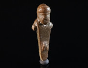 A ROMAN BRONZE MINIATURE OF A HERM Circa 1st-3rd century AD. Miniature square pillar topped by a bearded male head; with arm stumps and stylised male ...