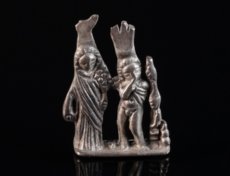 A ROMAN SILVER AMULET PENDANT OF ISIS AND HARPOCRATES The divine pair Isis and h...