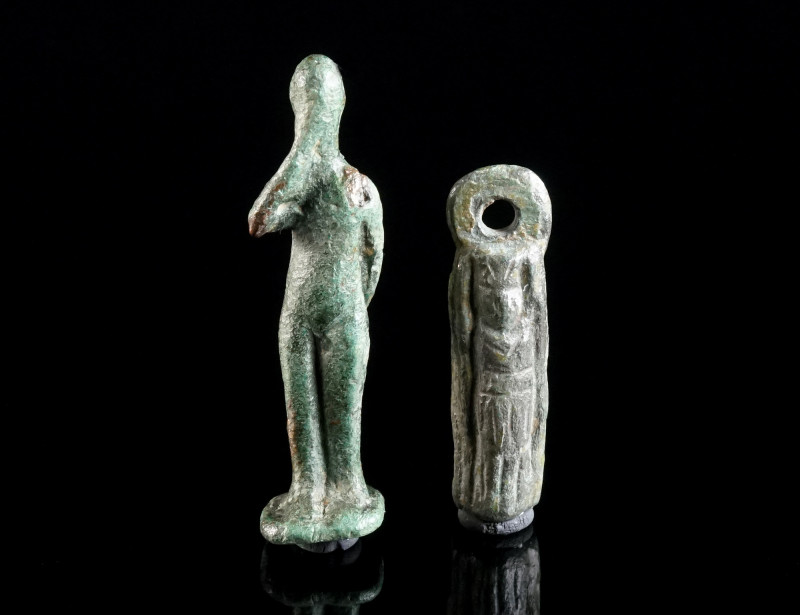 TWO ROMAN BRONZE FIGURAL AMULET PENDANTS Circa 2nd-3rd century AD. One probably ...