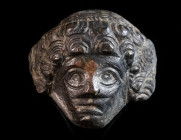 A ROMAN BRONZE APPLIQUE OF A WOMAN Circa 2nd-3rd century AD. Head of a woman with elaborate hairstyle. H 31 mm

Ex private collection, acquired on the...