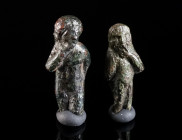 TWO ROMAN BRONZE AMULET PENDANTS DEPICTING HARPOCRATES Circa 2nd-3rd century AD. These small amulets are usually interpreted as depicting Harpocrates,...