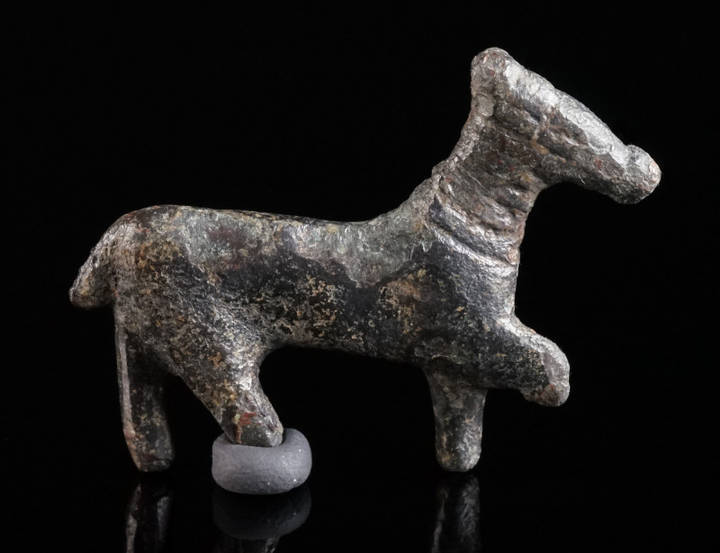 A ROMAN BRONZE FIGURE OF A HORSE Circa 2nd-3rd century AD. Figure of a striding ...