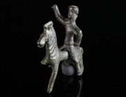 A ROMAN BRONZE STATUETTE OF A THRACIAN HORSE AND RIDER Circa 2nd-3rd century AD. The hero with long hair tied into a knot at the back of the head is w...