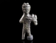 A SMALL ROMAN BRONZE STATUETTE OF MERCURY Circa 2nd-3rd century AD. Stylised representation of Mercury with winged cap and cloak, holding the herald's...