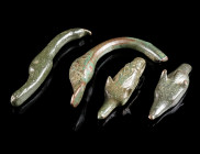 A GROUP OF FOUR ROMAN BRONZE TERMINALS WITH ANIMAL HEADS Circa 1st-2nd century AD. Two wolf heads and two duck heads; all most probably finals from th...