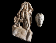 A ROMAN LEAD STATUETTE AND A HEAD OF VENUS Circa 2nd-3rd century AD. A half-draped statuette of Venus flanked by a small figure of winged Eros, both s...