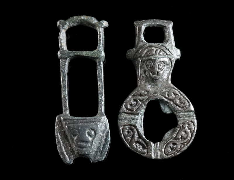 TWO BYZANTINE BRONZE CLOAK CLASPS WITH HEADS Circa 6th-8th century AD. One part ...