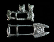TWO BYZANTINE/MEDIEVAL BRONZE FIGURAL CLOAK CLASPS Circa 6th-12th century AD. One part each of a two-part toggle fastening. One with a stylised head, ...