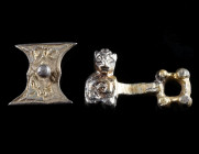 TWO BYZANTINE/MEDIEVAL SILVER-GILT ADORNMENTS Circa 12th-15th century AD. One part of a clasp with the bust of a creature (?); and a decorated fitting...